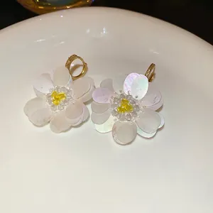 Sparkling iridescent sequin flower earrings with zircon centers and gold hoops