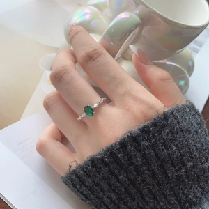 Detailed macro view of S925 silver ring featuring emerald zircon and leaf leaf-shaped crystals
