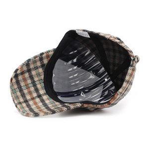 Detail of checkered baseball cap interior with 100% polyester wash label and metal buckle