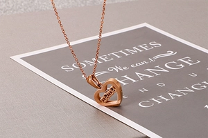 Macro shot of rose gold heart-shaped mama pendant necklace with polished finish