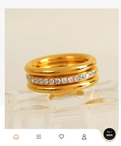 Macro detail of triple-layer gold ring with micro-set zircon stones on glass surface