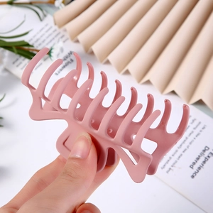 Macro shot of large pink matte geometric hair claw clip with cutout design