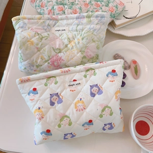 Close-up of quilted floral cosmetic bags with cotton fabric texture and soft padding