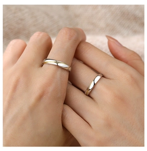 Close-up of S925 sterling silver couple rings with gold line detail on hands