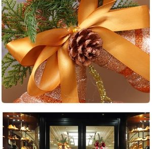 Detailed macro view of a Christmas gold ribbon bow with glitter pinecone and pine branches