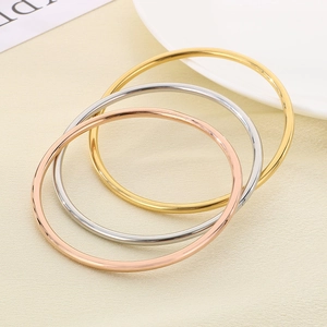 Three-color minimalist stackable bangles in gold, silver, and rose gold finishes