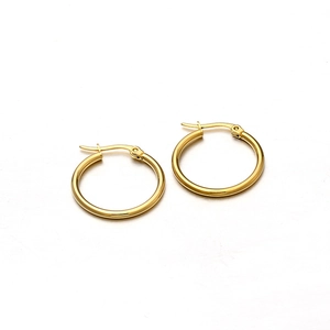 Close-up of golden minimalist hoop earrings featuring a secure snap-back closure on white base
