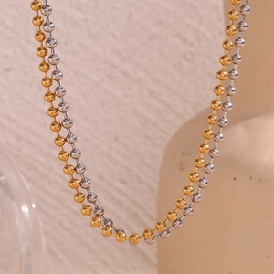 Detail of double-layer beaded necklace featuring 4mm gold and silver stainless steel balls
