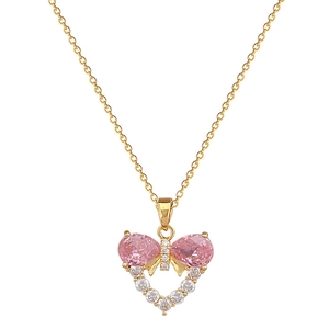 Elegant gold bow heart necklace with pink drop-shaped gems and sparkling zircon stones