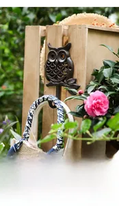 Vintage owl cast iron wall hook showing rustic texture with a hanging linen bag