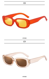 Detailed side view of orange and champagne retro narrow rectangular sunglasses frames
