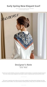 Detailed view of dark blue paisley silk scarf tied as a stylish headband on model