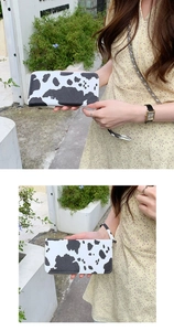 Detail of cow print PU leather wallet with zipper closure and detachable wristlet strap
