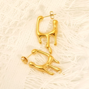 Modern gold-plated stainless steel lava earrings in liquid metal style on textured fabric