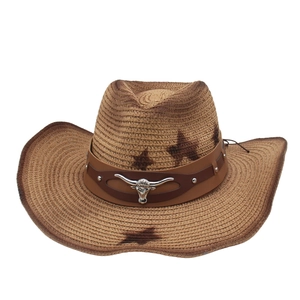 Woven straw cowboy hat with wide brim featuring a metal bull head emblem and leather band