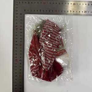 Detailed measurement of red and white striped Christmas gnome chair leg cover with ruler