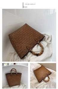 Detail of woven brown tote bag with natural bamboo handles and structured texture