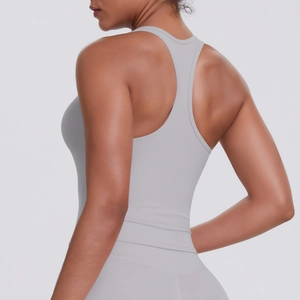 Detail of light blue racerback sports top showing slim fit and back design on model