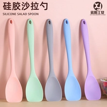 Detailed macro view of five silicone salad spoons in pastel colors with hanging holes
