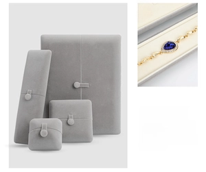 Macro view of grey velvet jewelry gift boxes showing premium texture and soft fabric