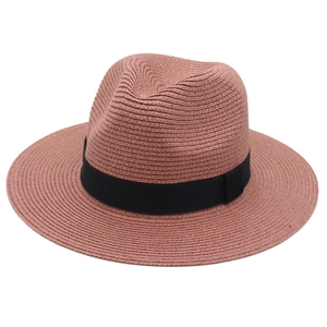 Detail view of the pink Panama straw hat featuring a classic black grosgrain ribbon band