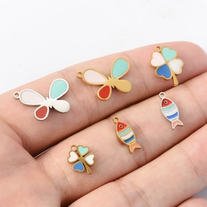 Macro shot of colorful enamel butterfly clover and fish charms for DIY jewelry
