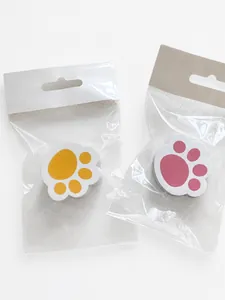 Detail view of pink and yellow cat claw cleaning sponges in hanging packaging