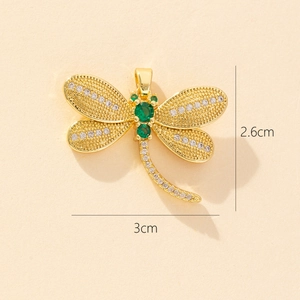 Detail view of a gold dragonfly pendant with green and white zircons and size measurements