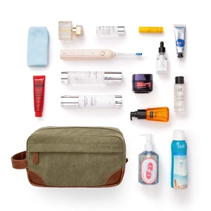 Vintage canvas and PU leather toiletry bag displayed with various grooming items