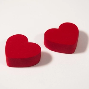Two red heart-shaped makeup sponges for dry and wet cosmetic application
