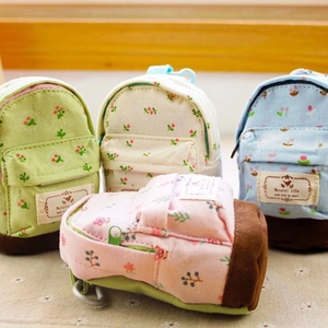 Detail of mini canvas coin purses with floral patterns and sturdy metal lobster clasps