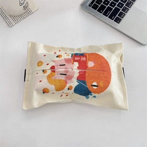 Detail of cartoon tissue box with cute pig illustration on cream cotton linen fabric