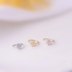 Macro shot of 0.8mm colorful zircon nose rings in silver, gold and rose gold finishes