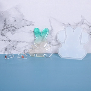 Macro shot of rabbit silicone mold with a green resin bunny and clear display stand