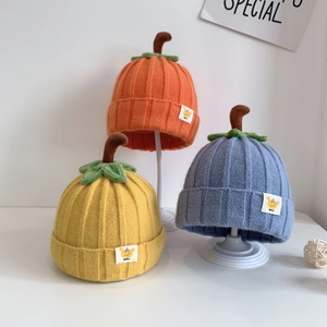Cute baby pumpkin knit hats in orange, yellow, and blue colors for autumn and winter