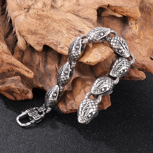 Macro view of detailed snake head clasp on retro 18k plated stainless steel bracelet