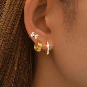 Detail of s925 silver gold earring set with a bow stud and hoop featuring S925 hallmark