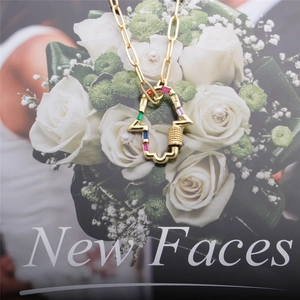 Gold Hamsa Hand necklace with colorful baguette gemstones and lobster clasp detail