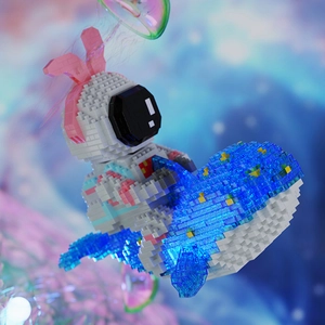 Detail of astronaut building blocks with pink rabbit ears riding on a blue whale