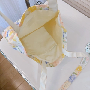 Macro view of the floral canvas tote interior featuring a practical open inner pocket
