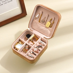 Detailed macro view of portable cork jewelry box with pink velvet lining and zipper