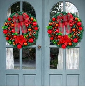 Close-up of Christmas wreath with red plaid bow, pine cones and berries on a blue door