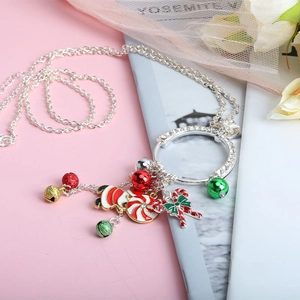 Christmas necklace with colorful bells and candy charms on a silver chain background