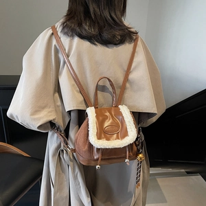 Brown faux fur trim mini backpack for women featuring plush piping and fashion logo plaque