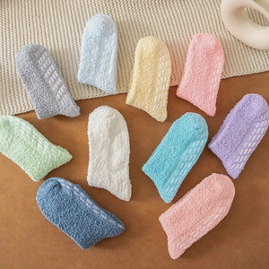 Detail shot of non-slip silicone grips on colorful thickened coral fleece floor socks