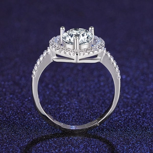 Macro shot of silver halo ring with round brilliant cut center stone and pave setting
