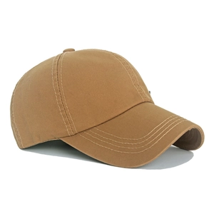 Side view of khaki washed cotton baseball cap with embroidered eyelets and curved brim