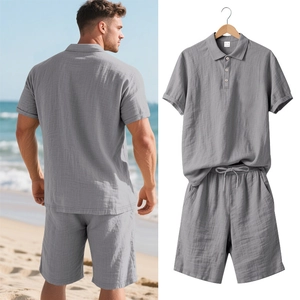 Detail of grey linen polo shirt and shorts set showing fabric texture and drawstring waist