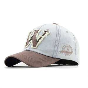 Vintage denim baseball cap with brown W letter patch and washed blue finish