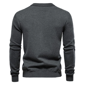 Detail view of the ribbed cuffs and dark grey fabric texture of the men's knitted sweater
